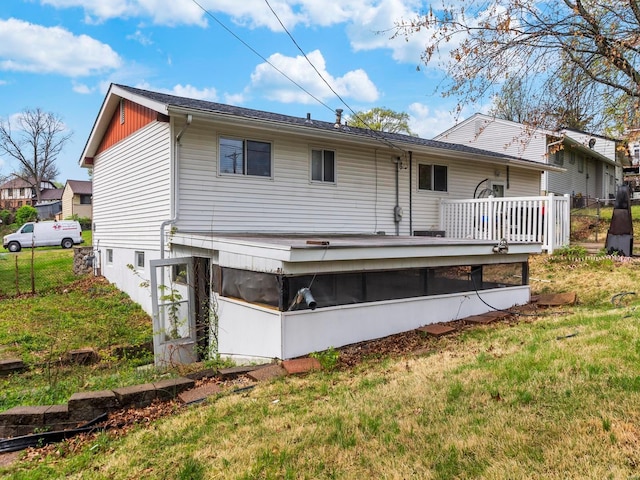 back of house featuring a wooden deck and a yard