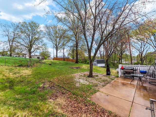 view of yard with a fenced backyard, an outbuilding, and a patio area