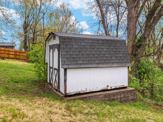 view of shed featuring fence
