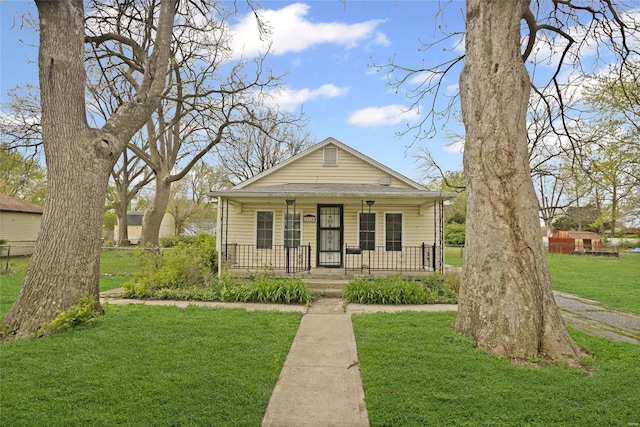 bungalow-style home with a porch and a front yard
