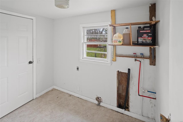 washroom featuring laundry area, baseboards, and electric dryer hookup