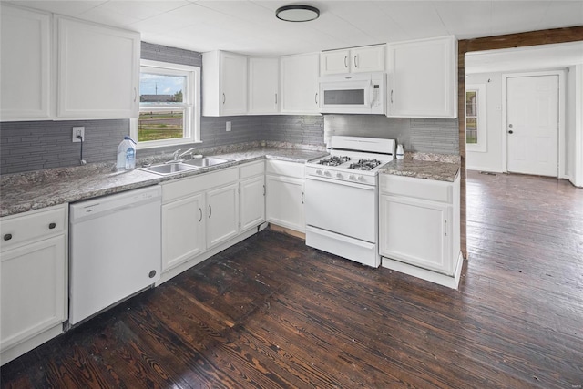 kitchen with white cabinets, a sink, decorative backsplash, white appliances, and dark wood-type flooring