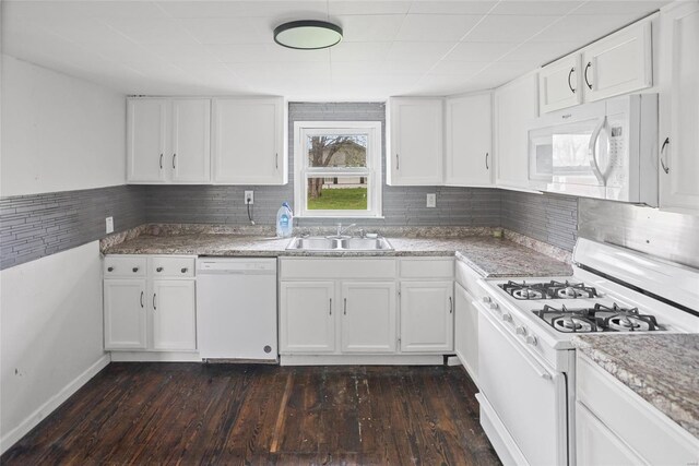 kitchen featuring dark wood-style flooring, white appliances, white cabinetry, decorative backsplash, and a sink