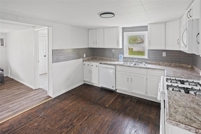 kitchen with dark wood finished floors, white appliances, white cabinetry, a sink, and decorative backsplash