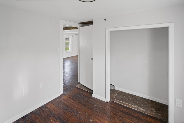 spare room with wood finished floors and baseboards