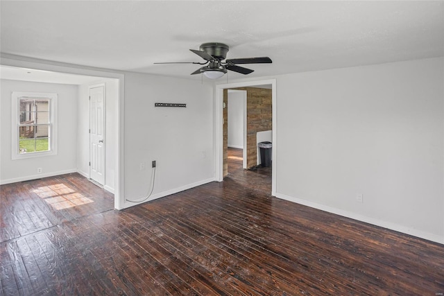 empty room with wood-type flooring, baseboards, and a ceiling fan