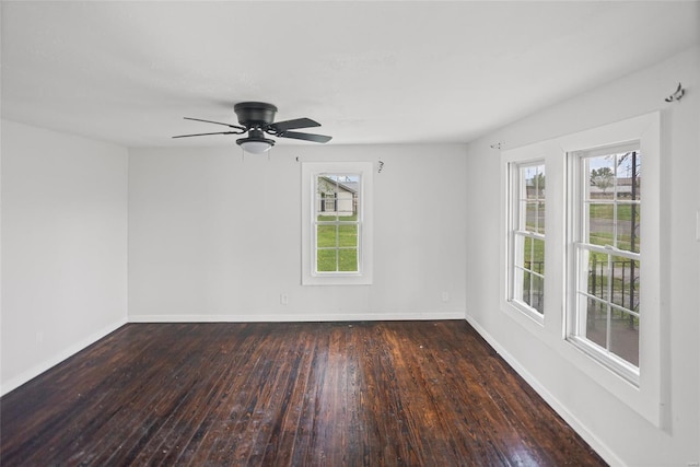 spare room with baseboards, hardwood / wood-style floors, a ceiling fan, and a healthy amount of sunlight