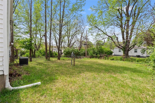 view of yard featuring fence and cooling unit
