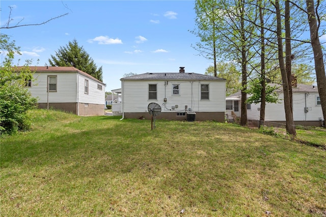 rear view of house with a lawn and fence