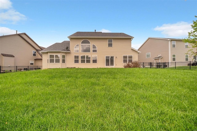 back of property featuring a yard and fence