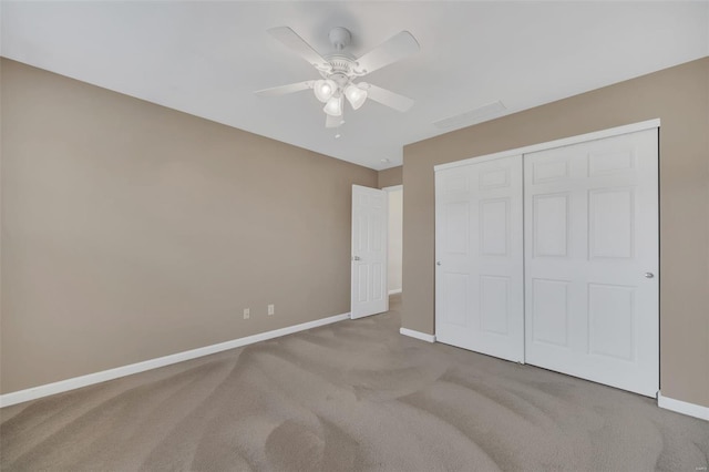 unfurnished bedroom featuring ceiling fan, visible vents, a closet, baseboards, and carpet