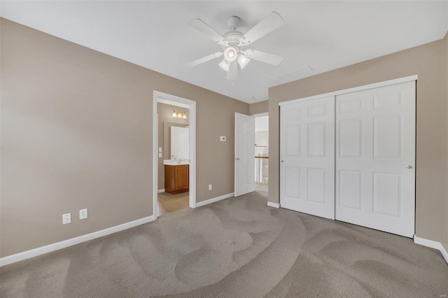 unfurnished bedroom featuring visible vents, a closet, light carpet, and baseboards