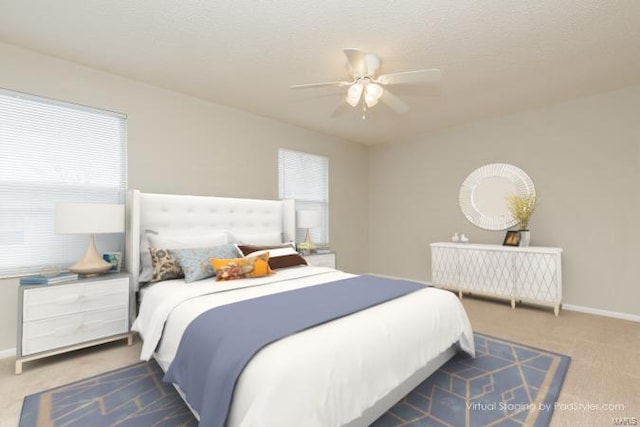carpeted bedroom with ceiling fan, baseboards, and multiple windows