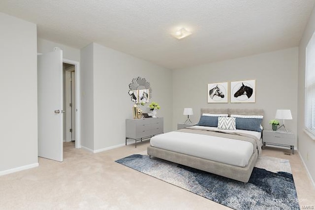 bedroom with baseboards and light colored carpet