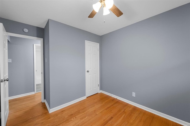 unfurnished bedroom with baseboards, ceiling fan, and light wood-style flooring