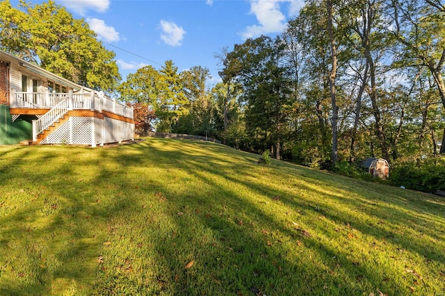 view of yard featuring a wooden deck and stairway