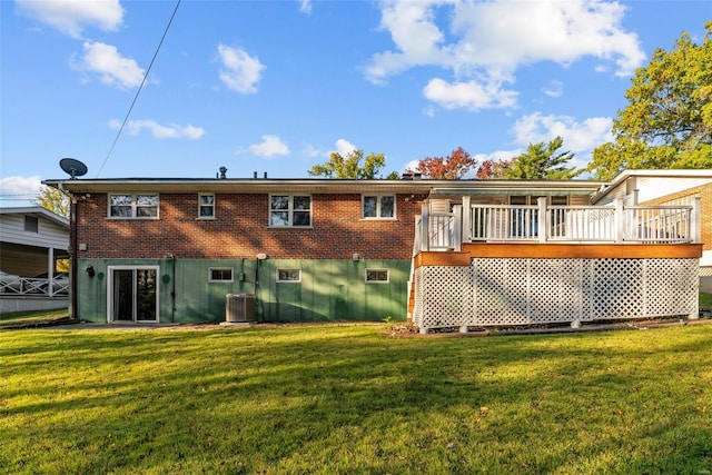 rear view of house with a wooden deck, a yard, central AC unit, and brick siding