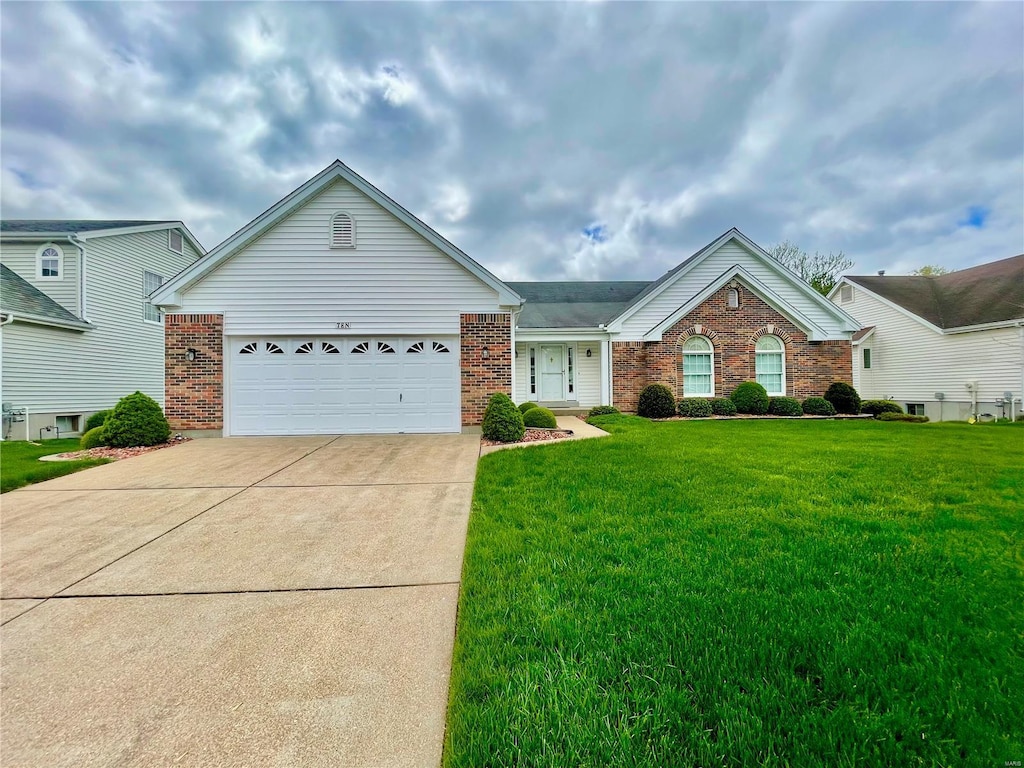 single story home with brick siding, a garage, driveway, and a front yard
