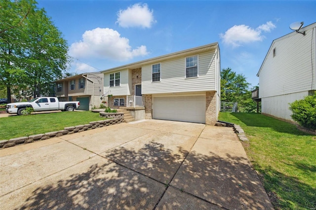 split foyer home featuring an attached garage, concrete driveway, a front lawn, and brick siding