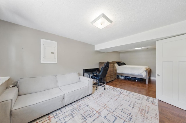 interior space with wood finished floors and electric panel