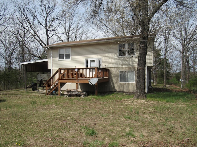 back of house featuring stairway, a yard, and a deck