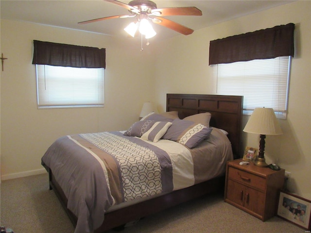 bedroom with light carpet, ceiling fan, and baseboards