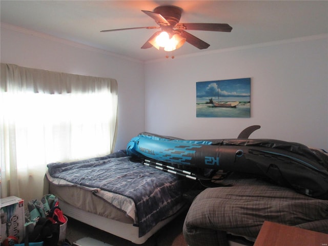 bedroom with crown molding and a ceiling fan