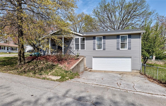 ranch-style home with fence, aphalt driveway, and a garage