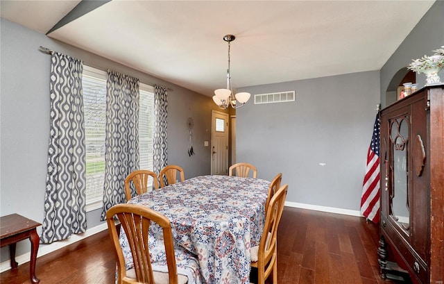 dining space featuring visible vents, baseboards, an inviting chandelier, and dark wood-style floors