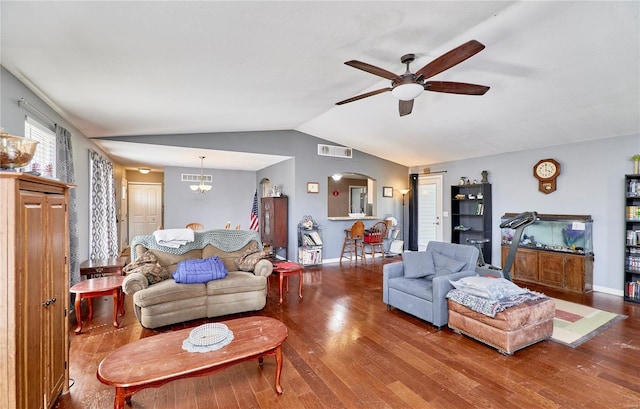 living area with vaulted ceiling, wood finished floors, visible vents, arched walkways, and ceiling fan with notable chandelier
