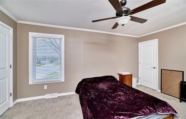 bedroom with crown molding, visible vents, multiple windows, and carpet floors