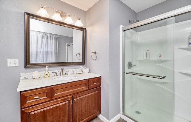 full bathroom with a shower stall and vanity