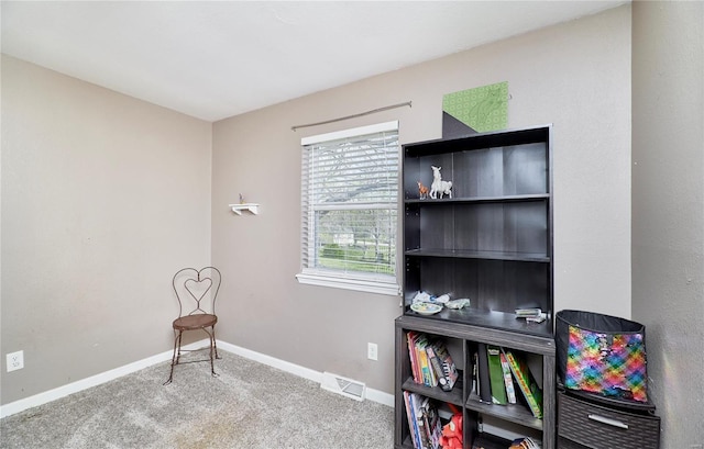 sitting room with visible vents, baseboards, and carpet floors