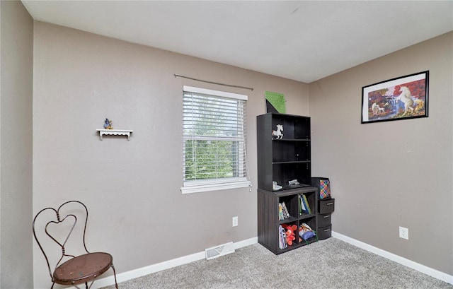 living area with visible vents, baseboards, and carpet flooring