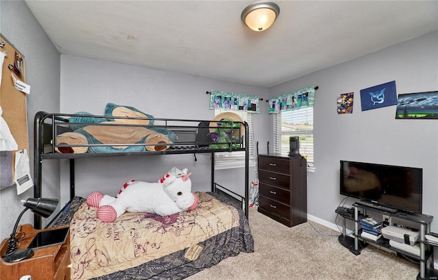 bedroom featuring baseboards and carpet floors