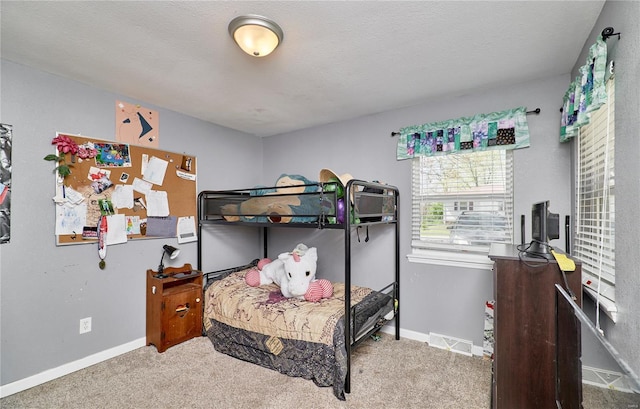 carpeted bedroom with visible vents and baseboards