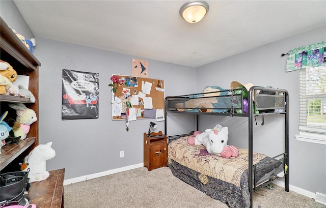 carpeted bedroom featuring baseboards and visible vents