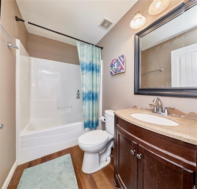 bathroom with visible vents, toilet, shower / bath combo with shower curtain, and wood finished floors