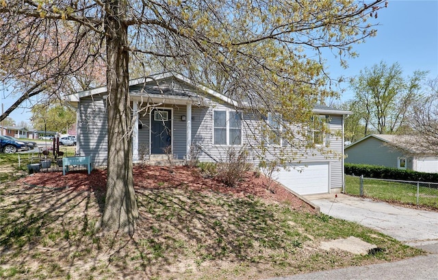 view of front of home featuring an attached garage, fence, and driveway