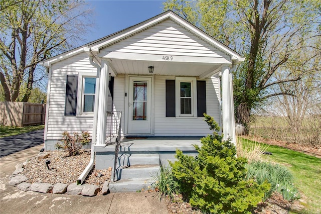 view of front of property with fence and a porch