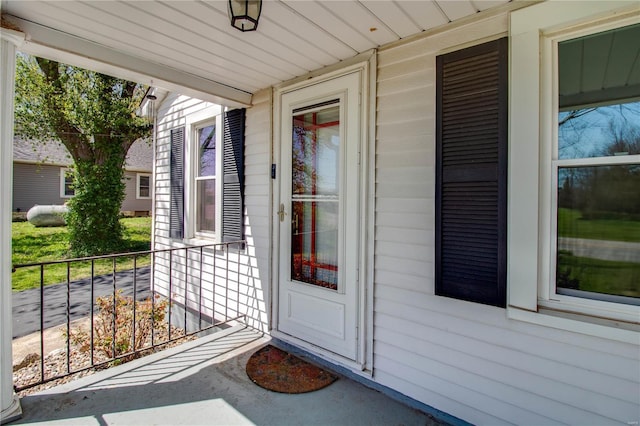 view of exterior entry with a porch
