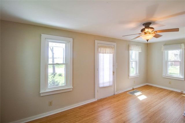 entrance foyer featuring a healthy amount of sunlight, light wood finished floors, and visible vents