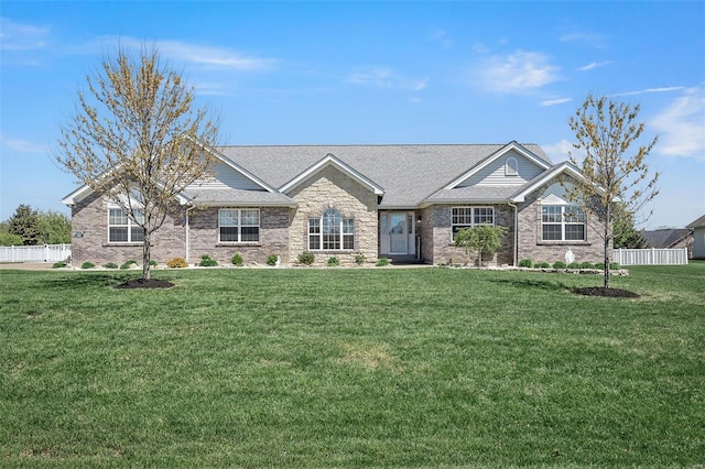 craftsman inspired home featuring fence, brick siding, and a front yard