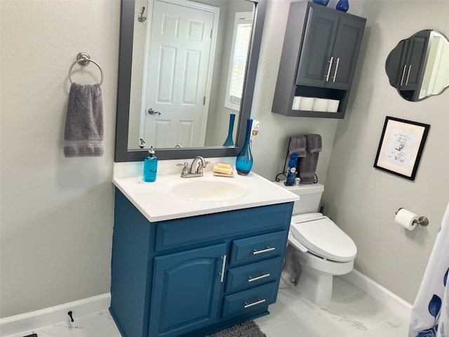 bathroom featuring baseboards, marble finish floor, toilet, and vanity
