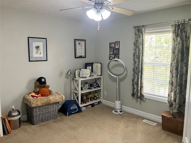 game room featuring carpet flooring, a ceiling fan, visible vents, and plenty of natural light
