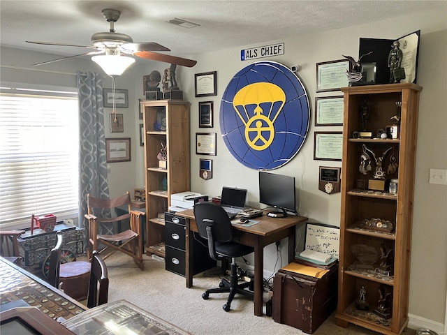 office featuring a ceiling fan, carpet flooring, and visible vents