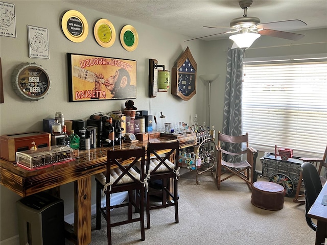 carpeted dining space with ceiling fan
