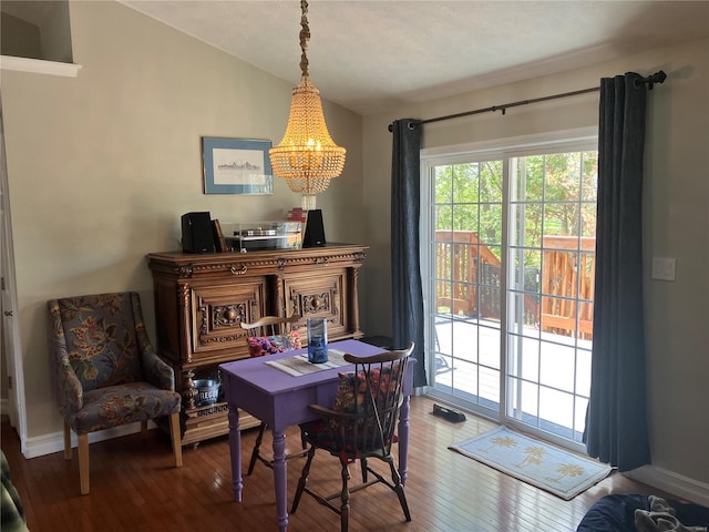 dining area featuring baseboards, a chandelier, lofted ceiling, and hardwood / wood-style floors