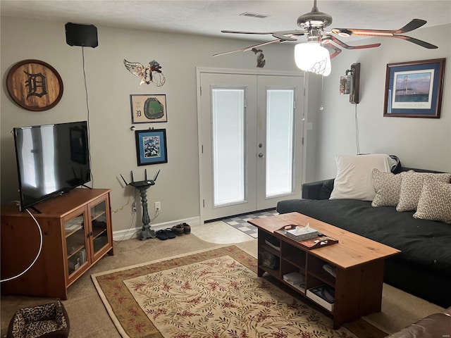 living room featuring visible vents, baseboards, ceiling fan, french doors, and carpet flooring