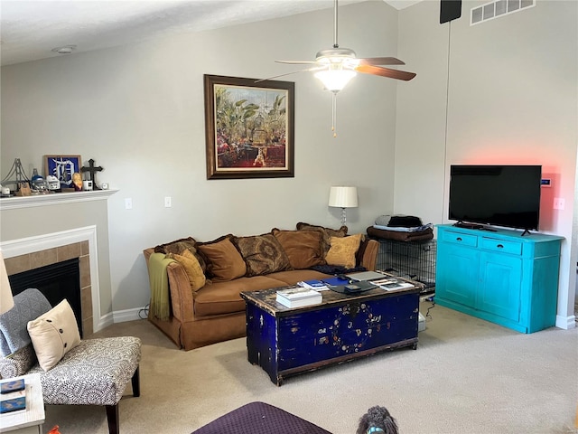 carpeted living area with visible vents, a fireplace, baseboards, ceiling fan, and vaulted ceiling